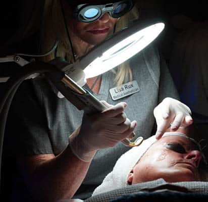 Lisa Rux performing microdermabrasion laser services.